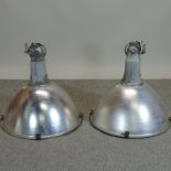 A pair of large industrial light fittings,