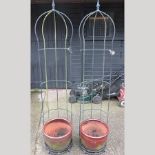 A pair of black painted iron garden arbours,