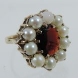 A 9 carat gold garnet and pearl ring