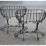 A pair of black painted iron oval garden planters,