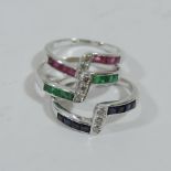 An 18ct white gold triple ring, with sapphires, emeralds,