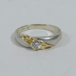 An 18 carat white and yellow gold single stone ring