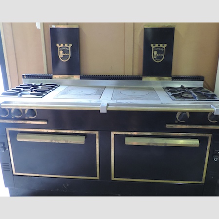 A French Forneaux Morice cast iron and brass range cooker, with a stainless steel top,