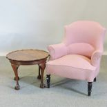 A Victorian pink upholstered armchair, together with a circular table,