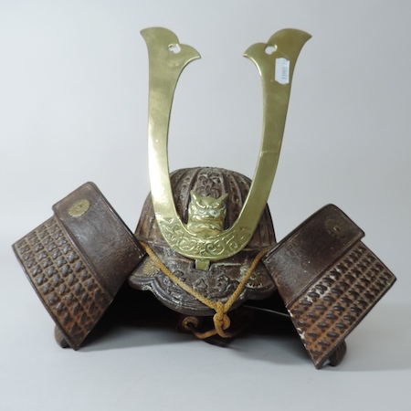 A Burmese brass mounted and iron military helmet,