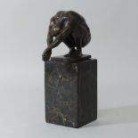 A bronze figure of a figure crouching,