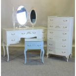 A white painted narrow chest of drawers, 60cm, together with a dressing table and mirror,
