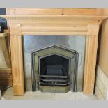 A pine fire surround, with a cast iron insert,