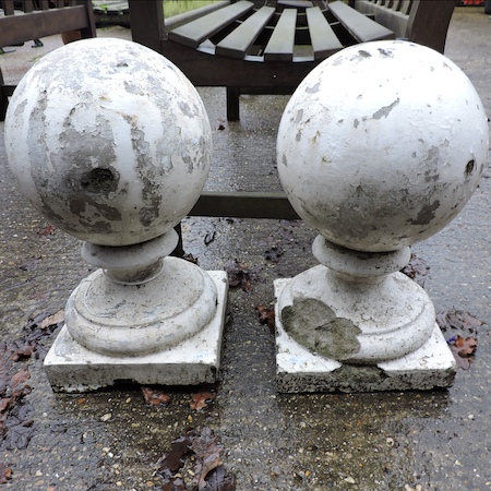 A pair of white painted marble ball finials,