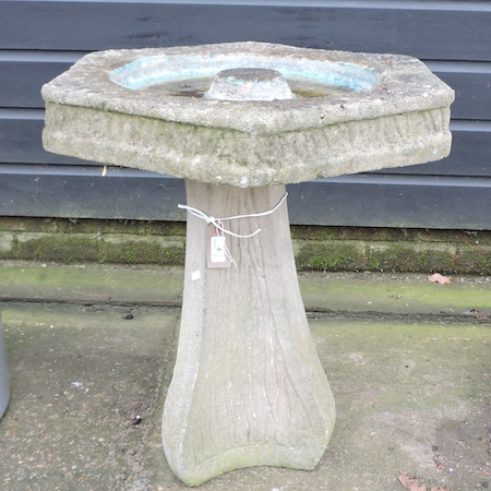 A reconstituted stone bird bath,