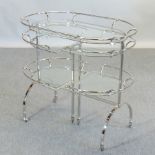 An Art Deco style tubular metal and glass drinks trolley, with adjustable shelves,