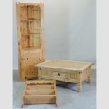 A modern pine corner cabinet, together with a pine hanging shelf and a coffee table,