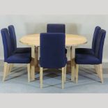 A modern beech circular dining table, with additional leaf, 173 x 130cm overall,