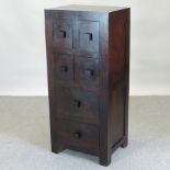 A hardwood chest, containing four short over two long drawers,