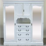 An early 20th century white painted wardrobe, with mirrored doors,