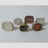 A collection of yellow metal and hardstone seals