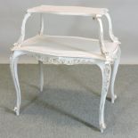 A white painted two tier etagere, on scrolled feet,