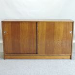 A contemporary oak bookcase, with sliding doors,