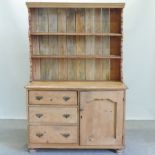 A 19th century pine dresser, on turned feet,