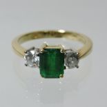 An 18 carat gold emerald and diamond ladies ring,