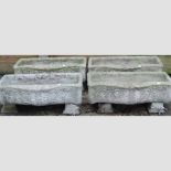 A set of four reconstituted stone troughs,