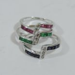 An 18 carat white gold triple ring, set with sapphires, emeralds,