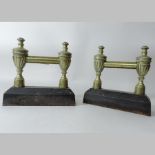 A pair of 19th century brass and cast iron fire dogs,