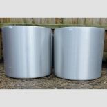 A set of four aluminium coloured circular garden planters,