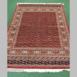 A Bokhara carpet, on a red ground,