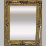 A large ornate gilt framed wall mirror,
