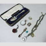 A silver teaspoon, cased, together with a ladies pocket watch, silver watch chain,