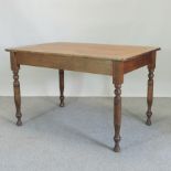 A Victorian pine kitchen table, on turned legs,