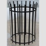 A black painted iron tree guard,