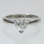 An 18 carat white gold and diamond solitaire ring, set with a heart shaped stone,