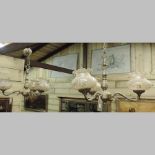 A pair of gilt metal three branch chandeliers, with coloured glass shades,