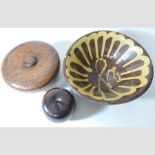 A lidded treen bowl, with a treen apple and slipware bowl,