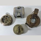 A collection of four reproduction brass compasses