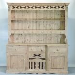 A pine dresser, with an arrangement of cupboards and drawers,