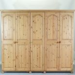 A large pine combination wardrobe, in three sections,