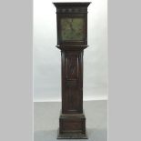 An early 20th century carved oak cased longcase clock, with an engraved brass dial, signed Maple,