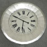 A silver painted wall clock,