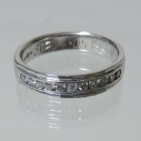 An 18 carat white gold and diamond half hoop eternity ring,