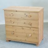 A modern pine chest of three drawers,