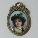 German School, early 20th century, a portrait miniature of a boy, oil on porcelain, in a gilt mount,