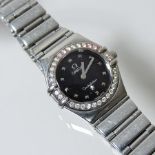 An Omega Constellation steel cased ladies wristwatch, with a diamond set bezel, on a flexible strap,