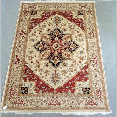 A Heriz carpet, with a central medallion, on a beige ground,