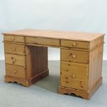 A modern pine pedestal desk,