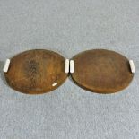 A pair of Art Deco ebony and ivory mounted hardwood trays, each of circular shape,