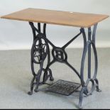 A sewing machine table, on a cast iron base,