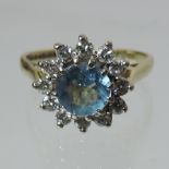 An 18 carat gold aquamarine and diamond cluster ring,